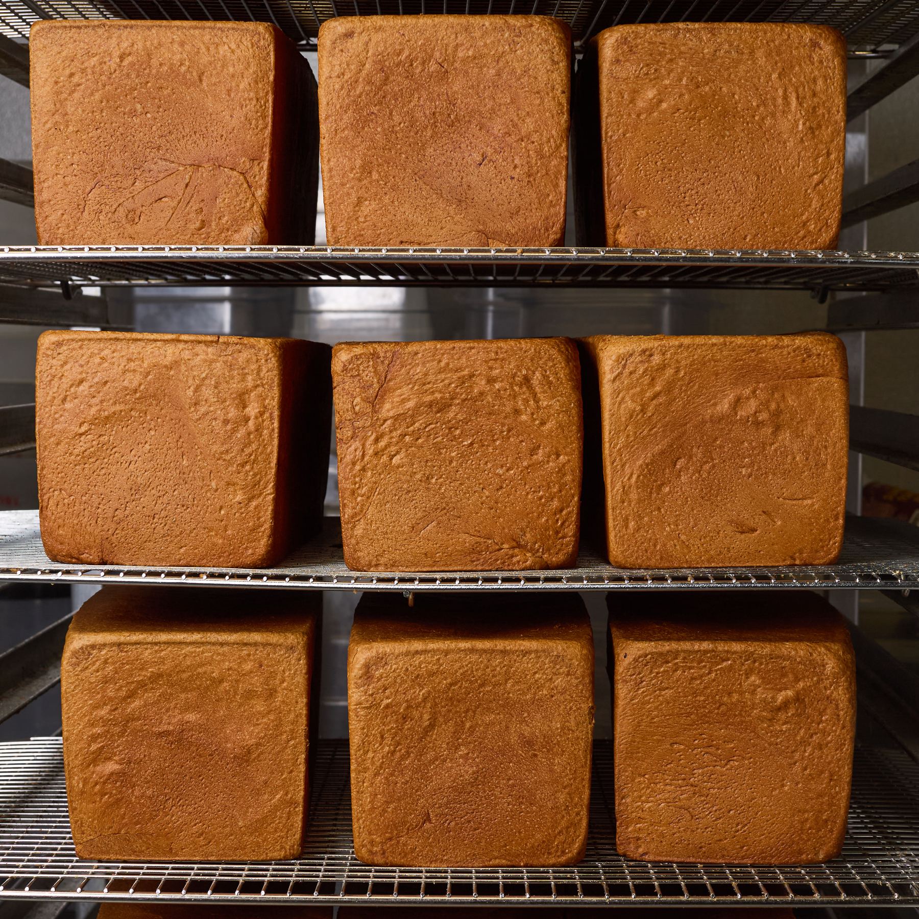 Pullman loaves cooling on bakery racks
